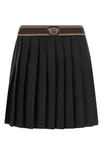 the versace pleated mini skirt exemplifies sartorial precision through its struc