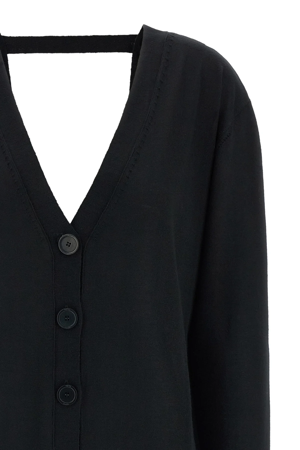the pure wool cardigan nude redefines the codes of knitwear through a fluid and