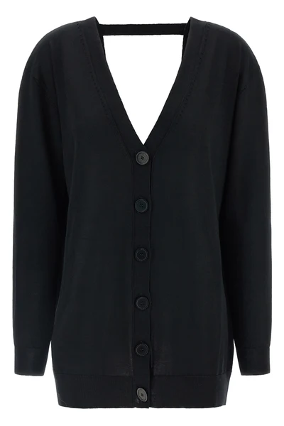 the pure wool cardigan nude redefines the codes of knitwear through a fluid and