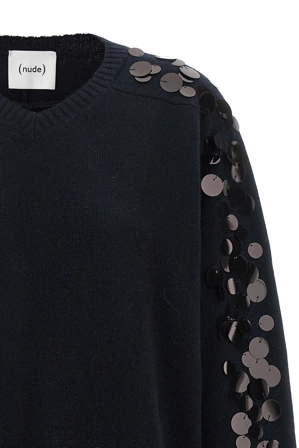 the nude knit redefines contemporary knitwear through a bold material contrast
