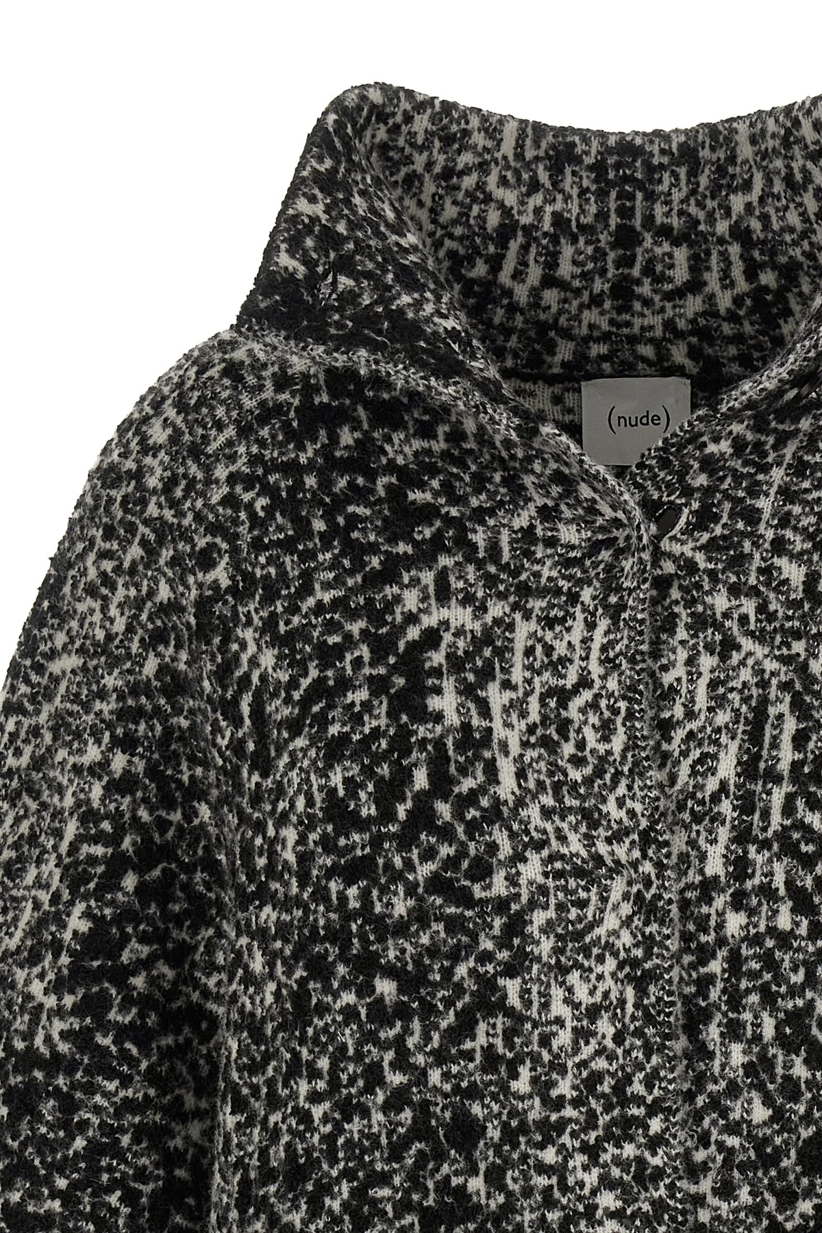 the nude knit coat redefines the volumes of contemporary outerwear through a cap