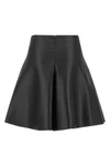 the nude mini skirt defines a flared silhouette