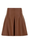 the nude mini skirt defines a flared silhouette