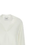 the nude blouse is distinguished by a fluid and deconstructed silhouette