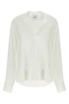 the nude blouse is distinguished by a fluid and deconstructed silhouette