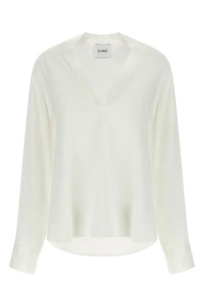 the nude blouse is distinguished by a fluid and deconstructed silhouette
