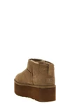 the ugg ankle boots redefine the brands iconic silhouette through bold proporti