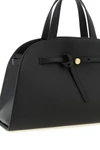 the romy tory burch trunk bag stands out for its structured and rounded silhouet