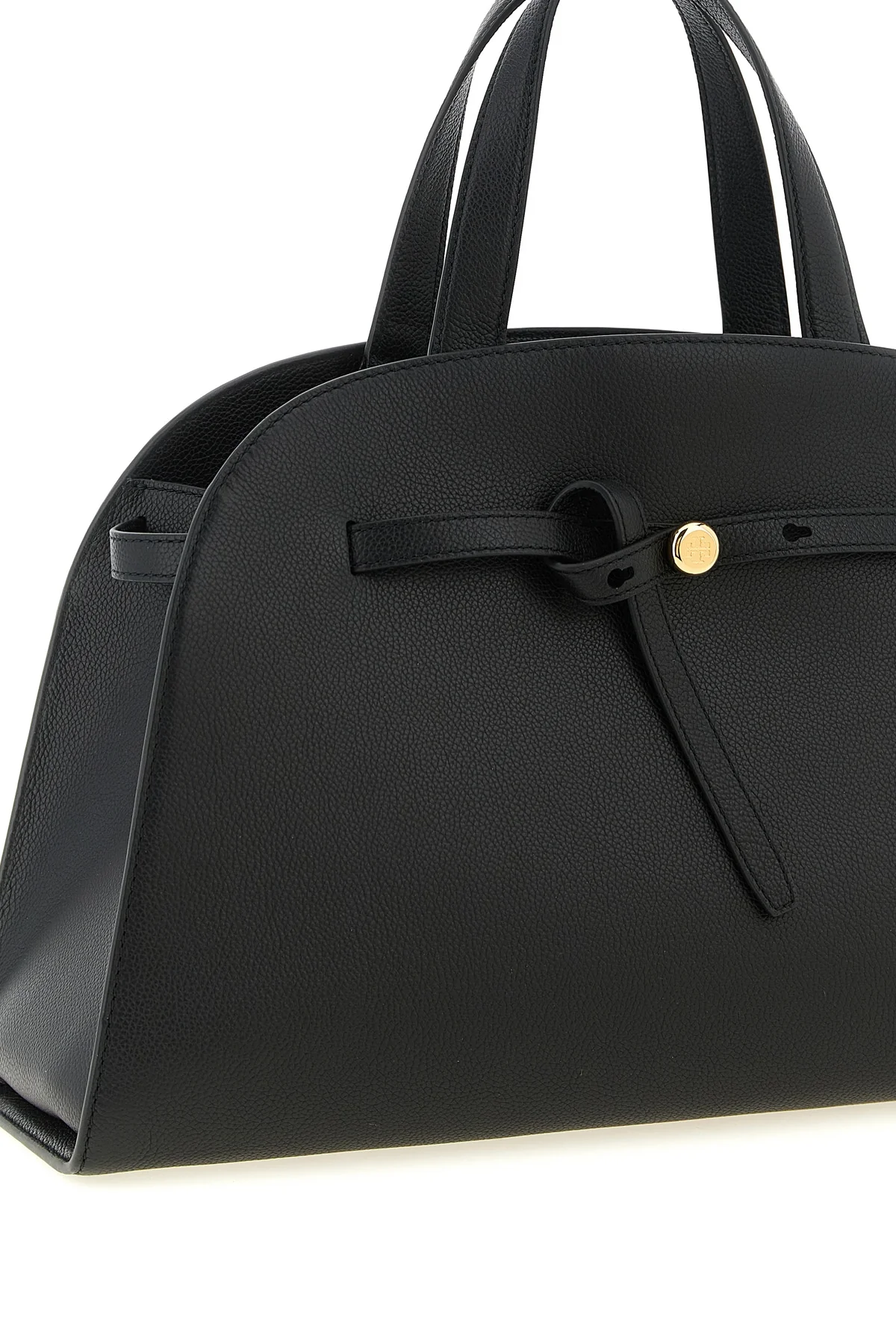 the romy tory burch trunk bag stands out for its structured and rounded silhouet