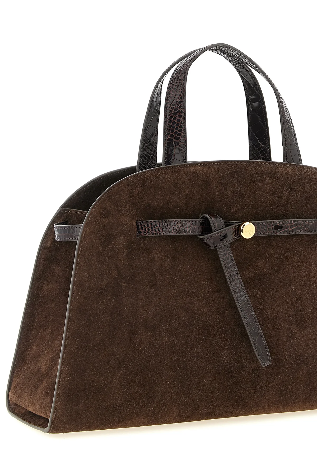 the tory burch romy trunk bag embodies a material elegance through the contrast