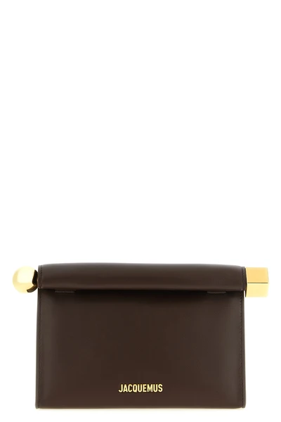 the jacquemus le sac rond carré clutch is distinguished by a structured silhou