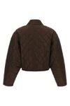 prada cropped blouson defines a new functional aesthetic through compact volumes