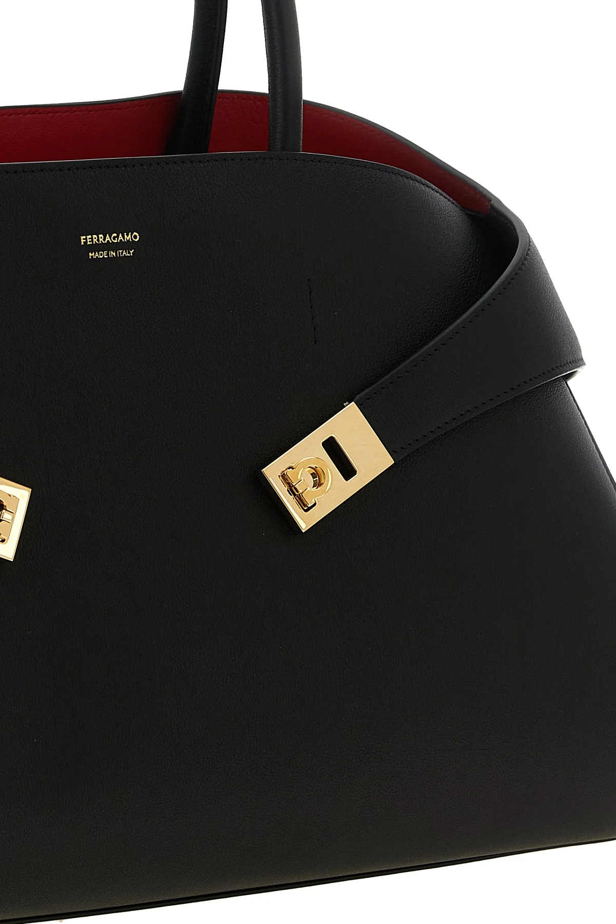 the ferragamo hug m handbag sets new standards of structured luxury through an