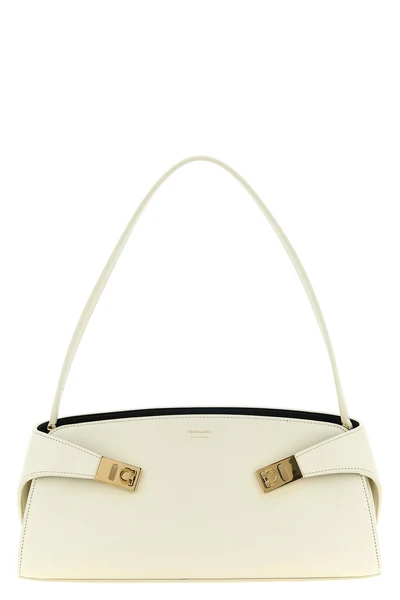 the ferragamo hug east-west shoulder bag in calf leather embodies sculptural e