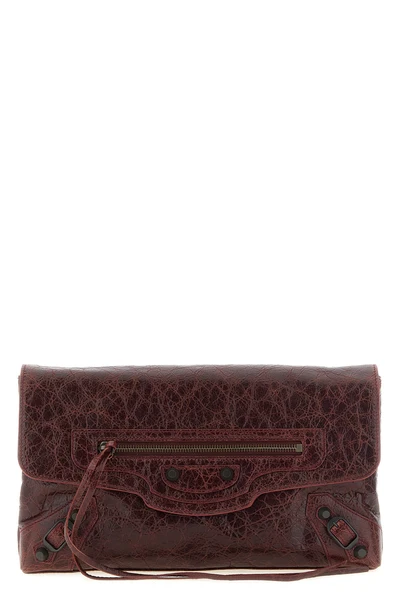 balenciagas le city clutch bag redefines urban elegance through a deconstruct