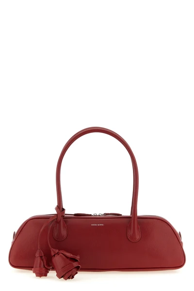 the magda butrym brigitte trapeze handbag defines a new geometry through an el
