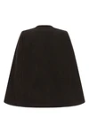 the ganni cape redefines the volumes of the outerwear through a flared and envel