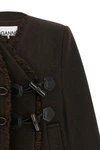 the ganni cape redefines the volumes of the outerwear through a flared and envel