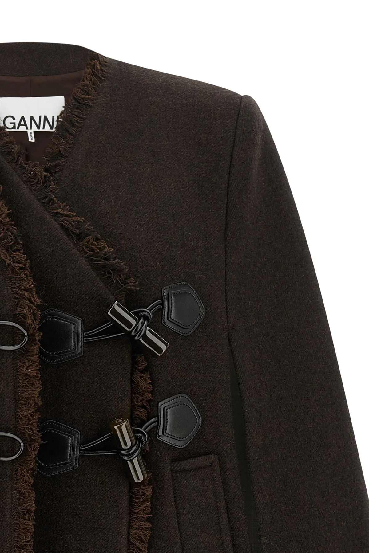 the ganni cape redefines the volumes of the outerwear through a flared and envel