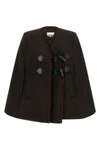 the ganni cape redefines the volumes of the outerwear through a flared and envel