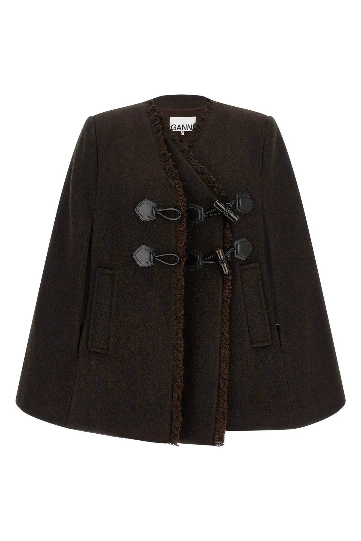 the ganni cape redefines the volumes of the outerwear through a flared and envel