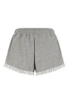 the ganni isoli shorts redefine casual style through a precise balance of text