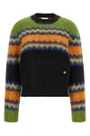 the ganni sweater redefines traditional knitwear through a bold play of color co