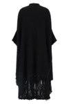 the dolce & gabbana bouclé cape stands out for its large volume