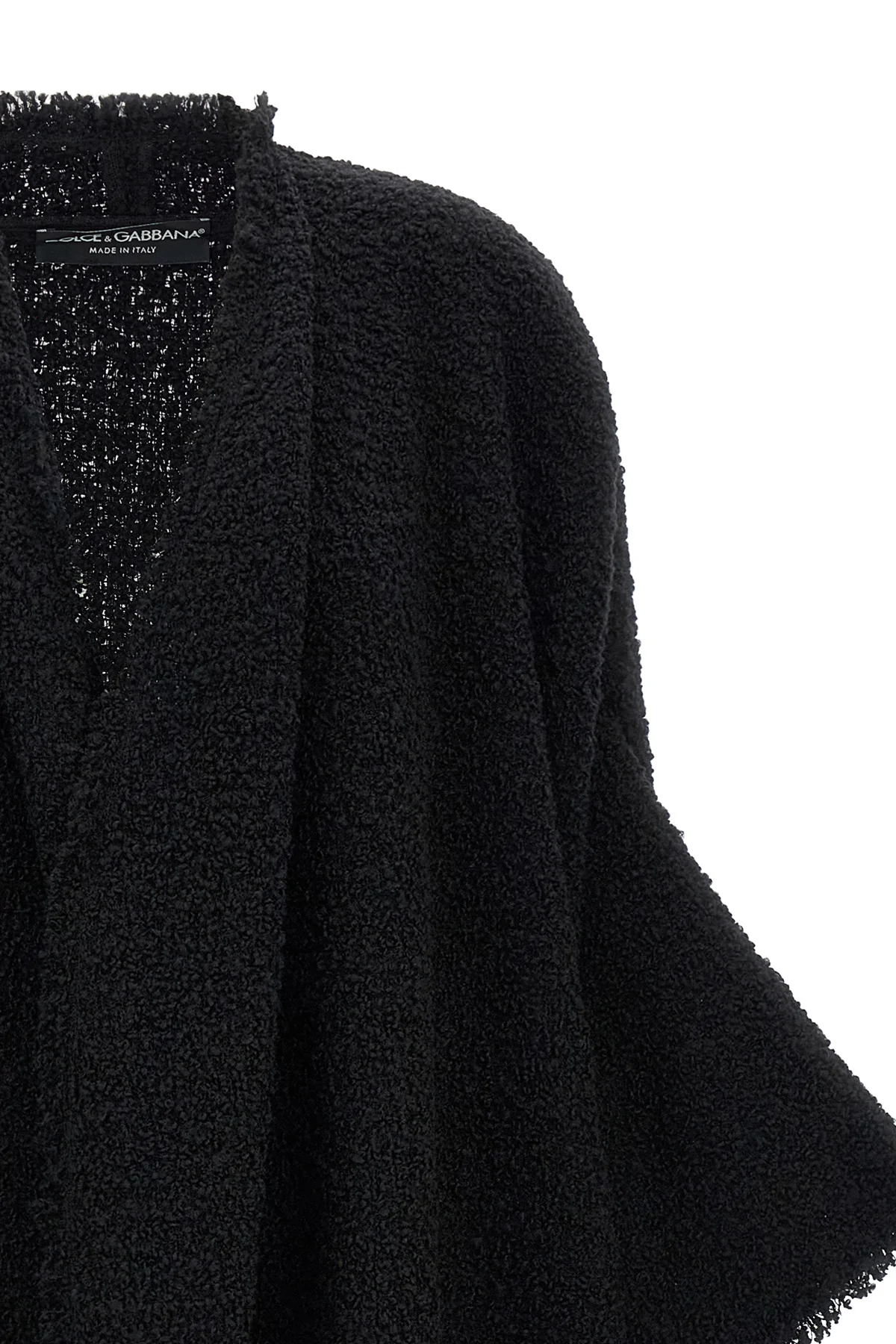 the dolce & gabbana bouclé cape stands out for its large volume
