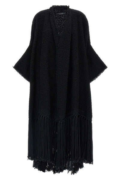 the dolce gabbana bouclé cape stands out for its large volume