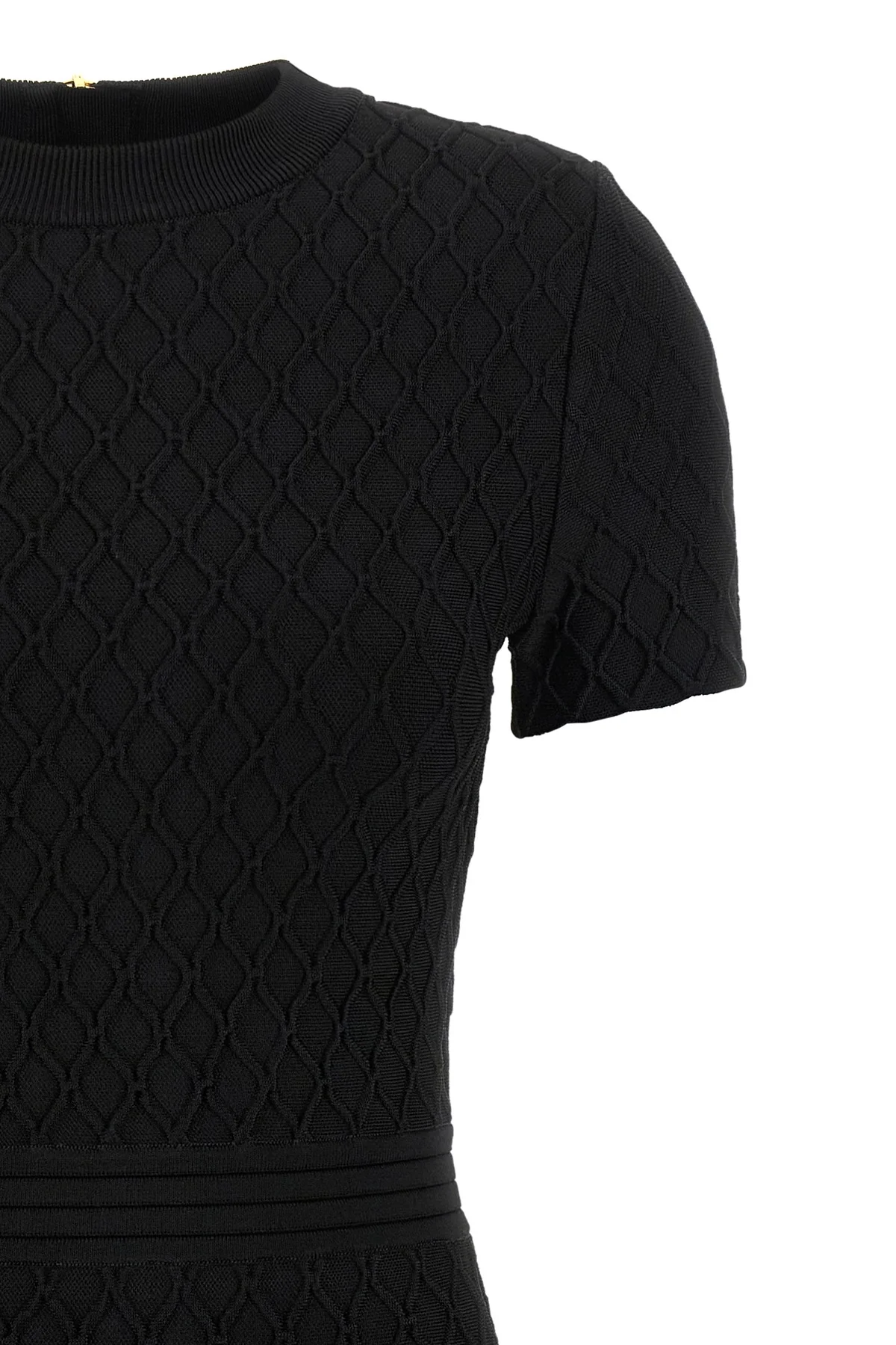 the flared balmain skater dress redefines knitwear codes through an hourglass