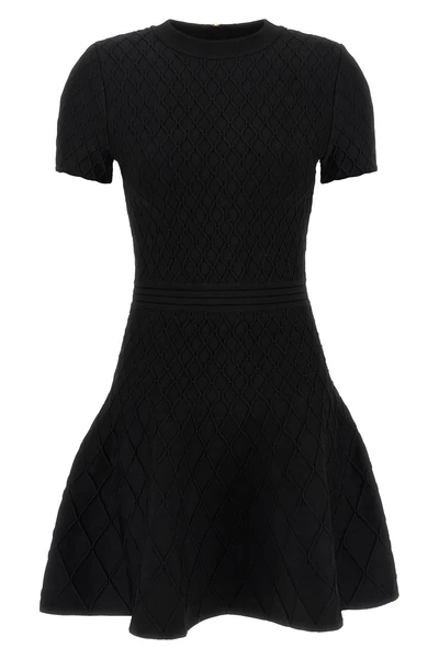the flared balmain skater dress redefines knitwear codes through an hourglass