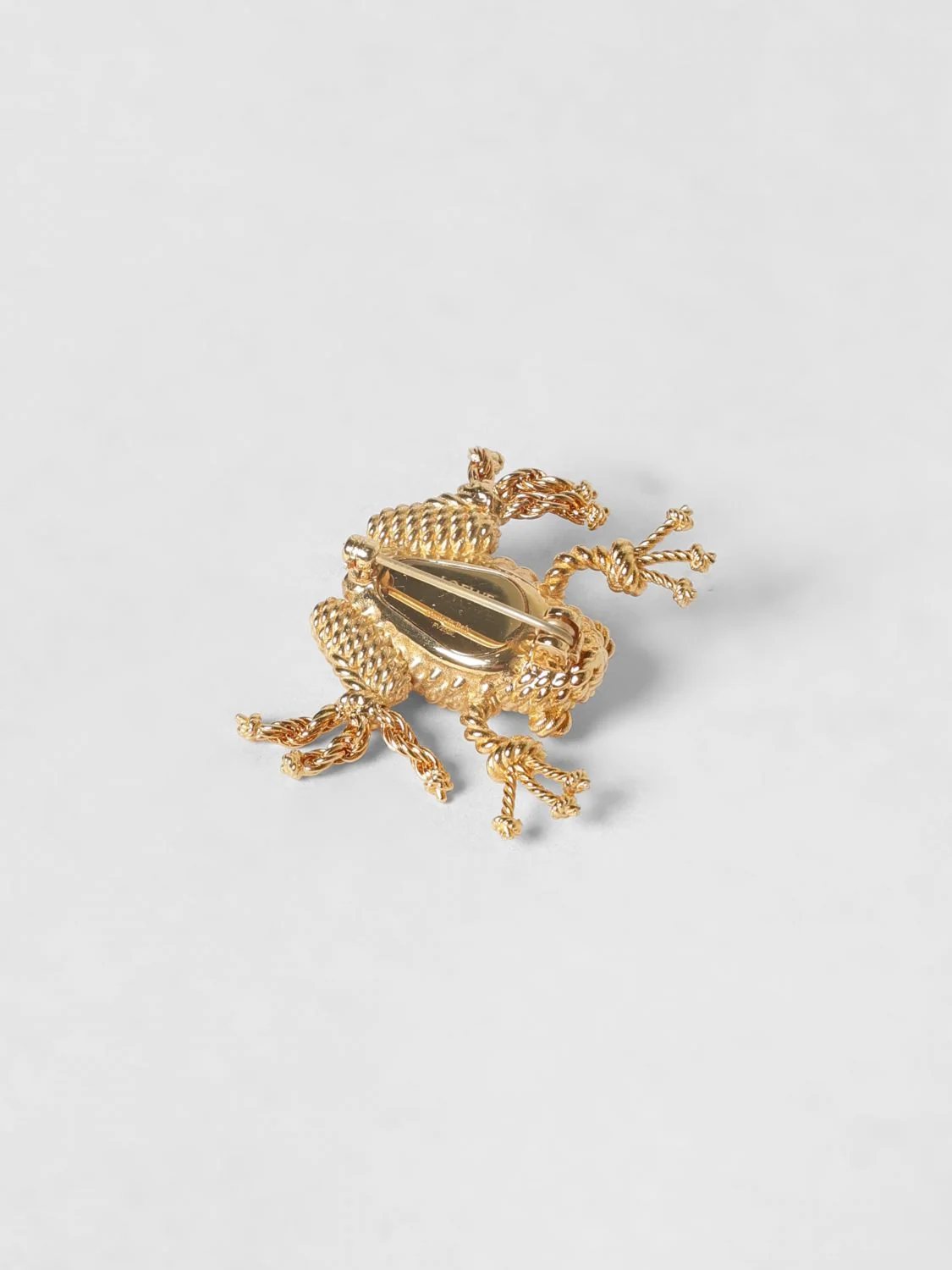 rana gold-coloured brass brooch with engraved logo