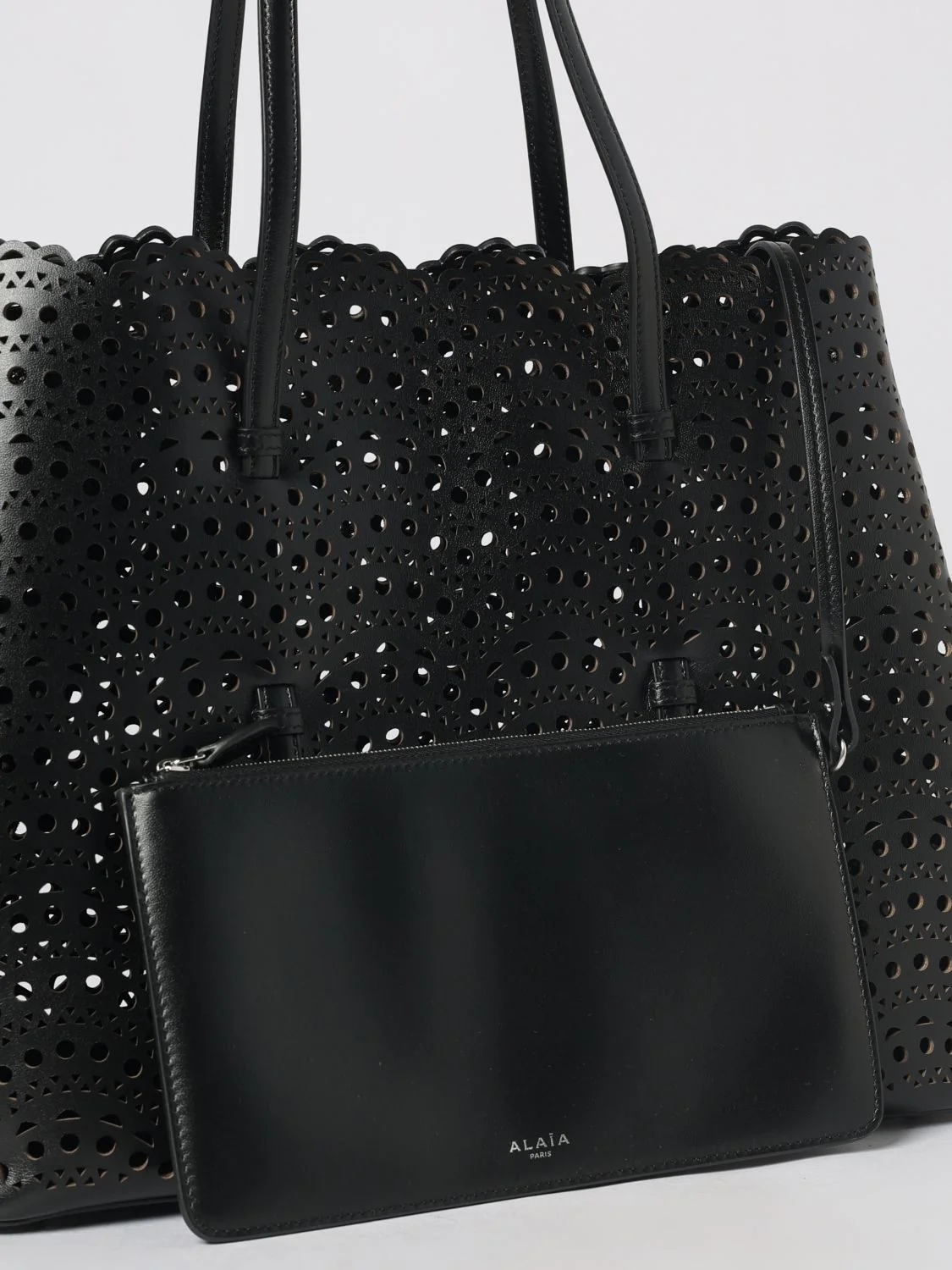 mina shoulder bag in smooth calfskin leather with perforated design and pouch