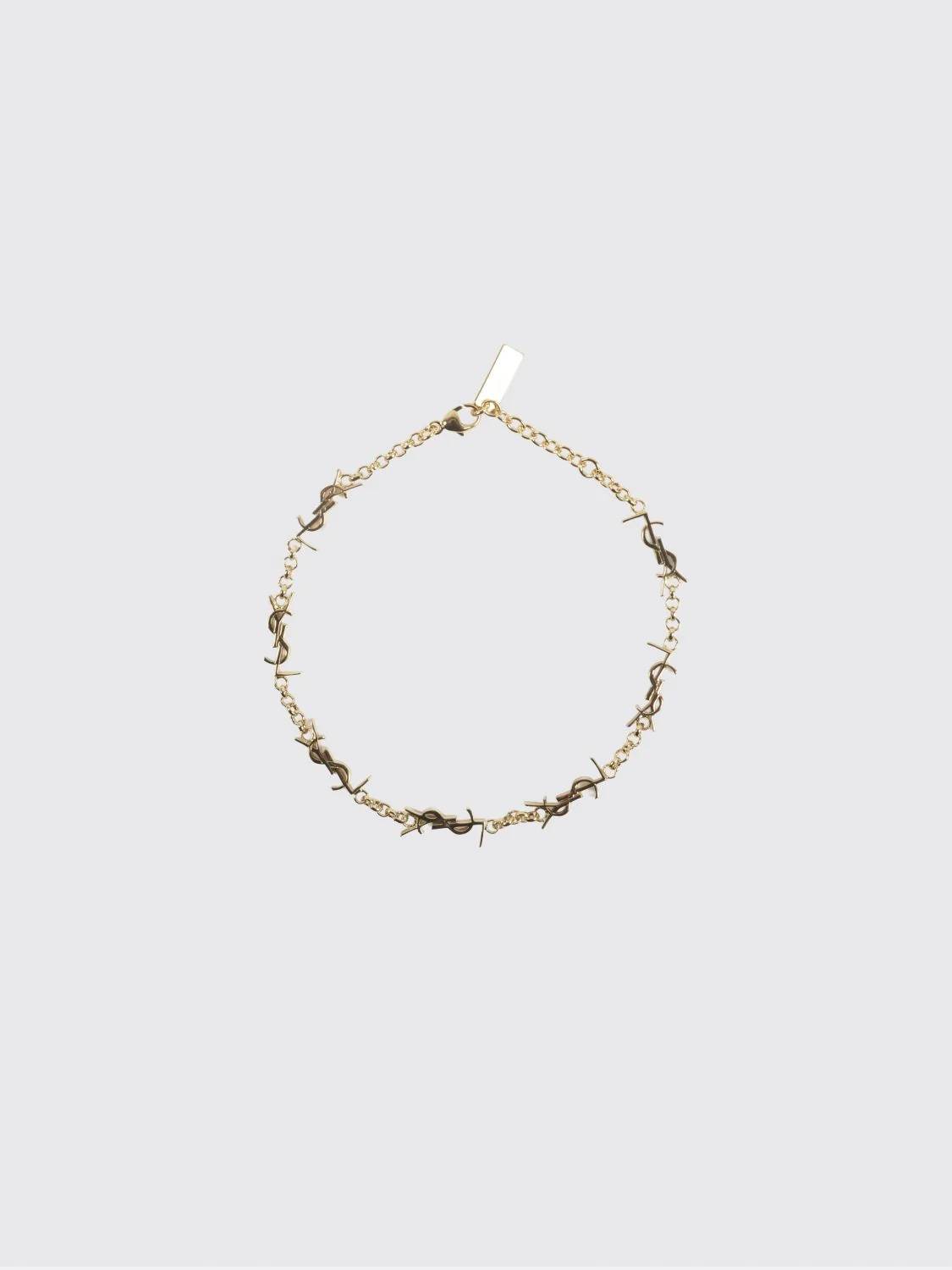 gold-tone metal bracelet with interlaced ysl monogram pendant