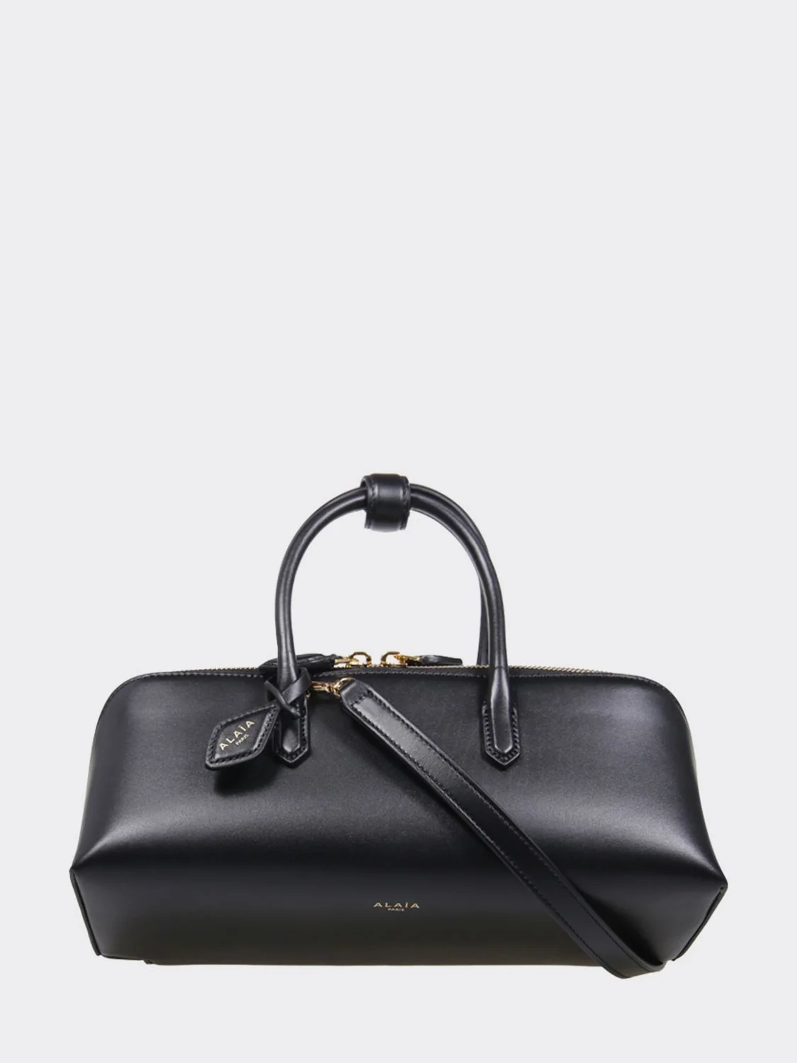 small leather handbag with double tubular handle and logo charm
