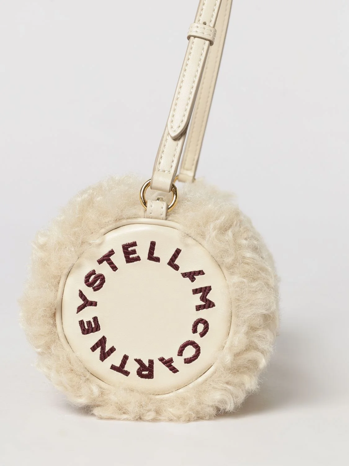 cylindrical shearling shoulder bag with adjustable handle