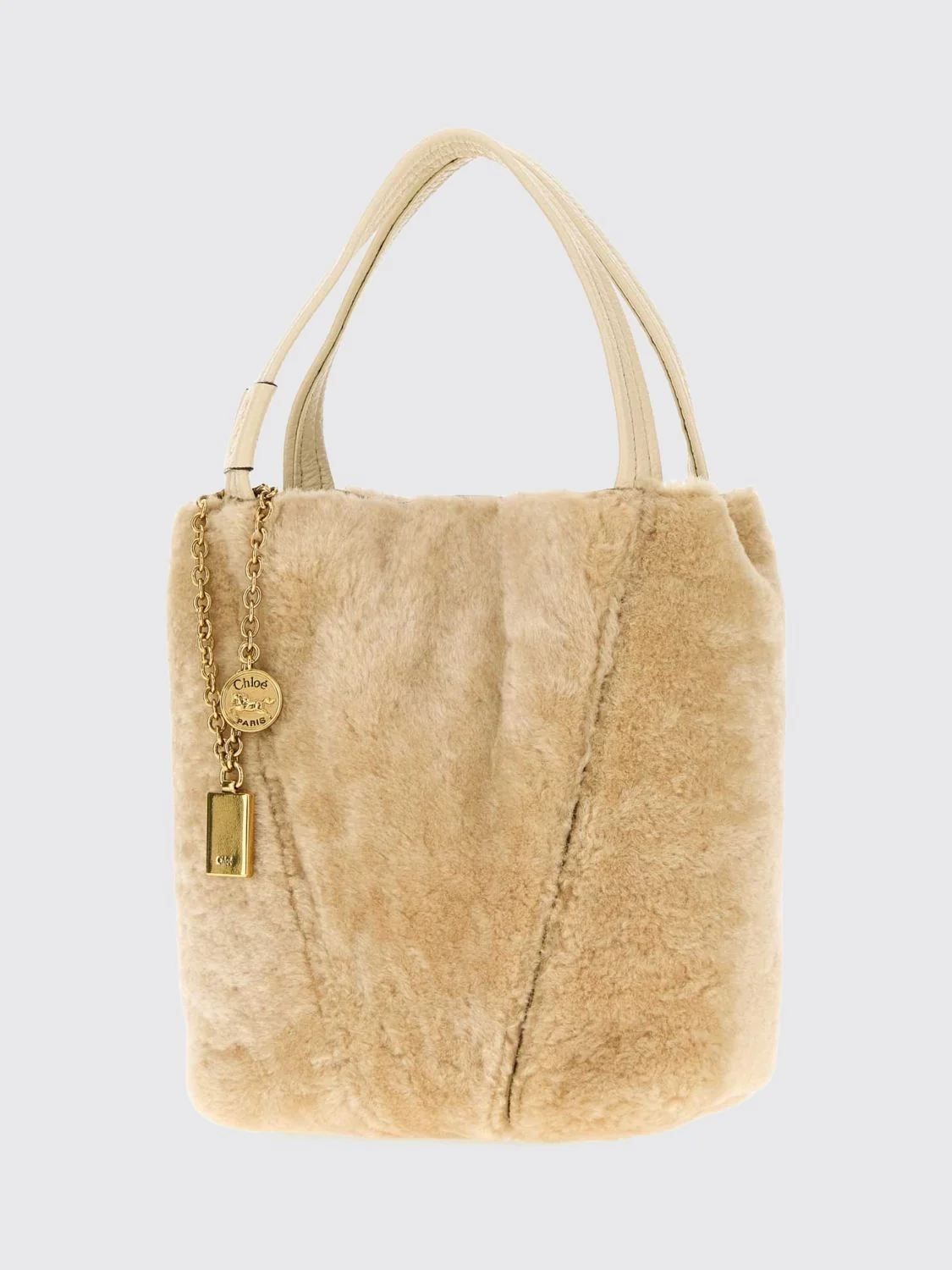 chloé spin shearling shoulder bag with double handle and decorative charm