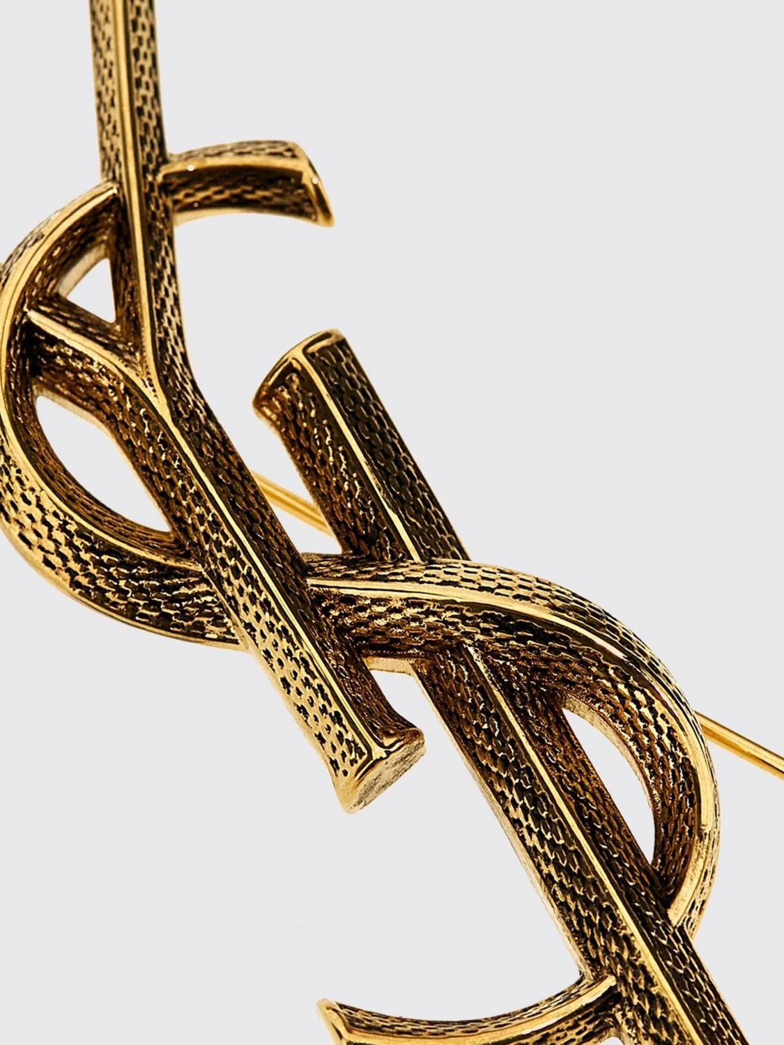 cassandre ysl monogram brooch in golden brass