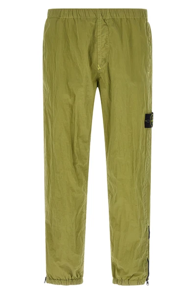 3100035 joggers in stone island nylon metal fabric subjected to a double wrink