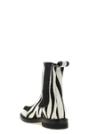 moschinos chelsea ankle boots redefine urban aesthetics through world-class man