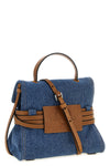 moschino tie me small denim handbag reinterprets urban codes through a contras