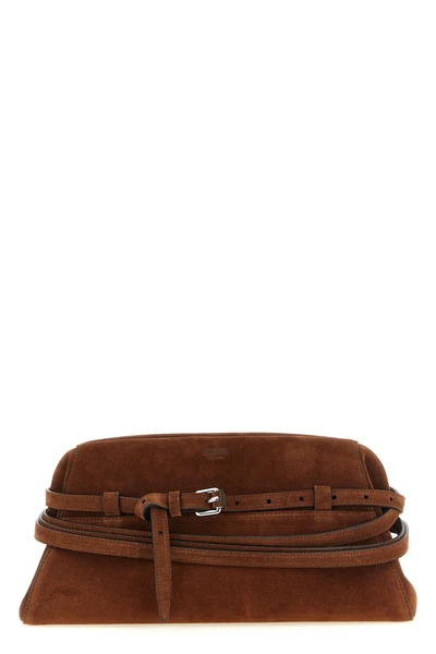 the moschino large tie me cutch in soft tobacco-colored suede stands out for i